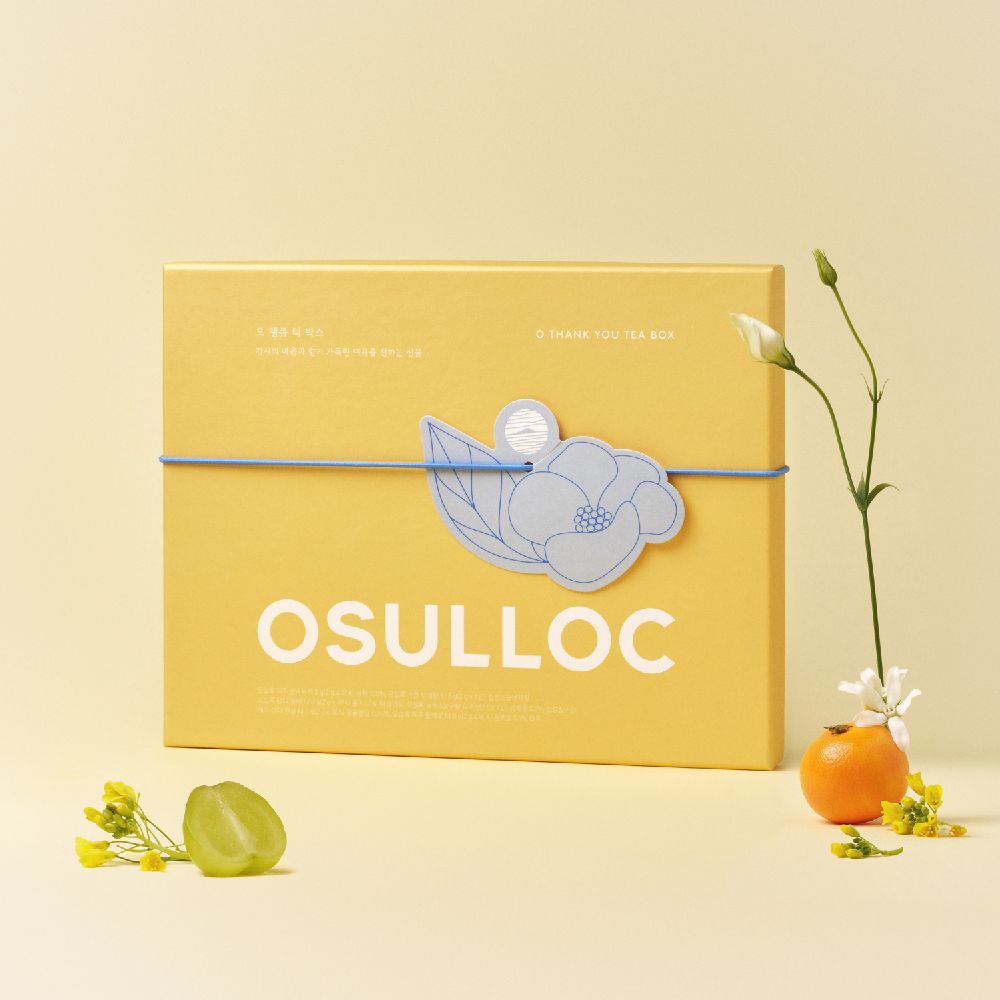 Boîte jaune OSULLOC Oh Thank You Tea fermée, ruban bleu et motif de camélia