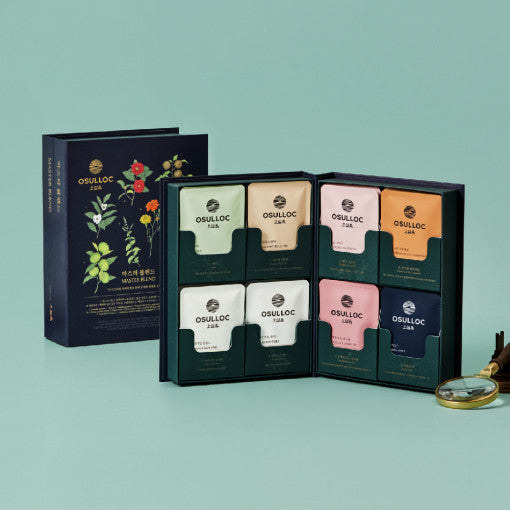 Coffret noir ouvert OSULLOC Master Blend montrant les différents thés colorés et le sac cadeau vert signature à côté.